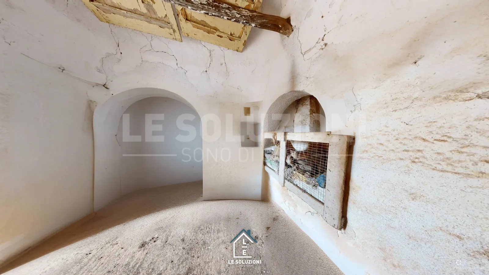 Interno trullo con archi in pietra e nicchia murata – Trulli a Putignano